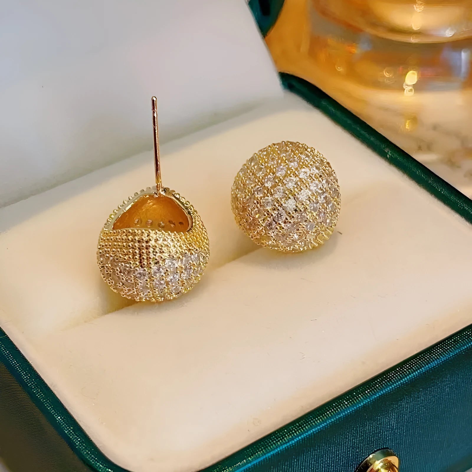 Golden beans drop-shaped earrings with full diamond embellishment and geometric design