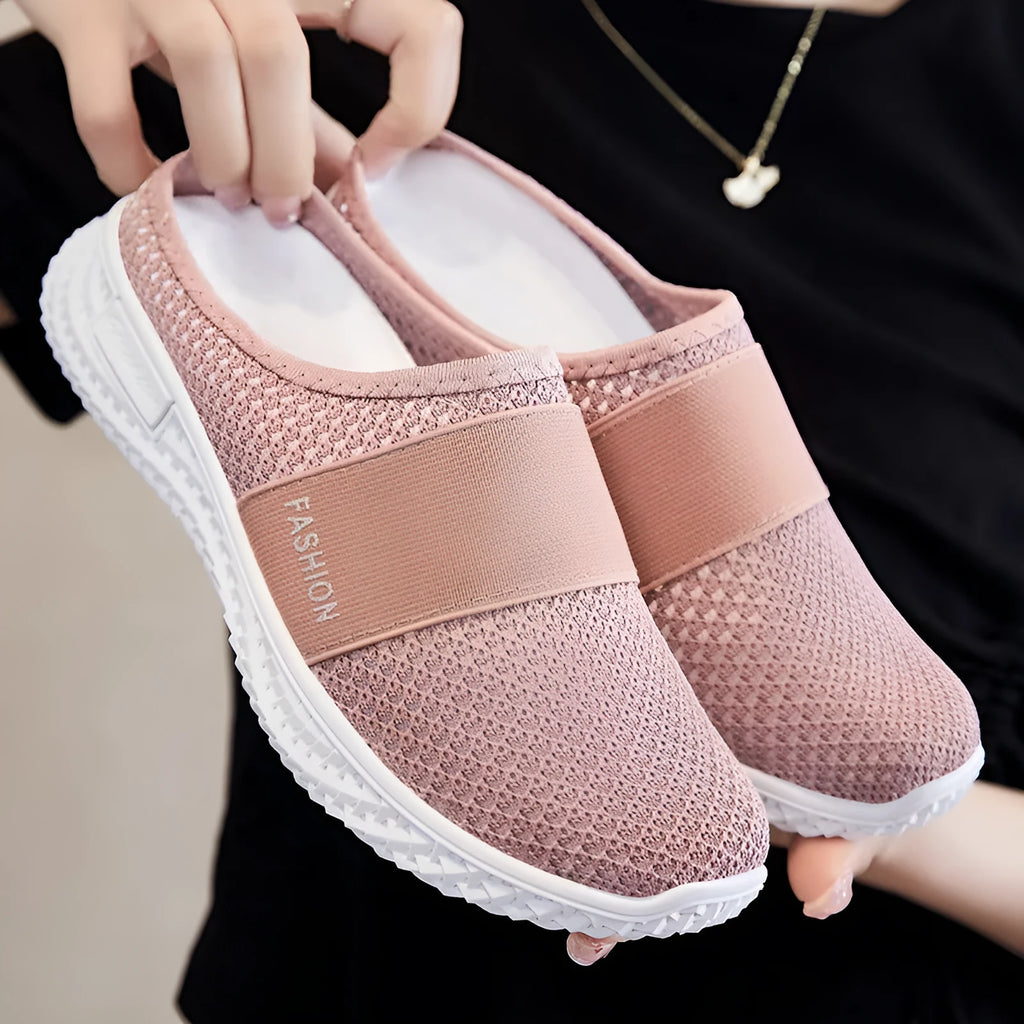 Women's casual flat shoe in breathable mesh, showing hollow-out detail and round toe, in a choice of colours.