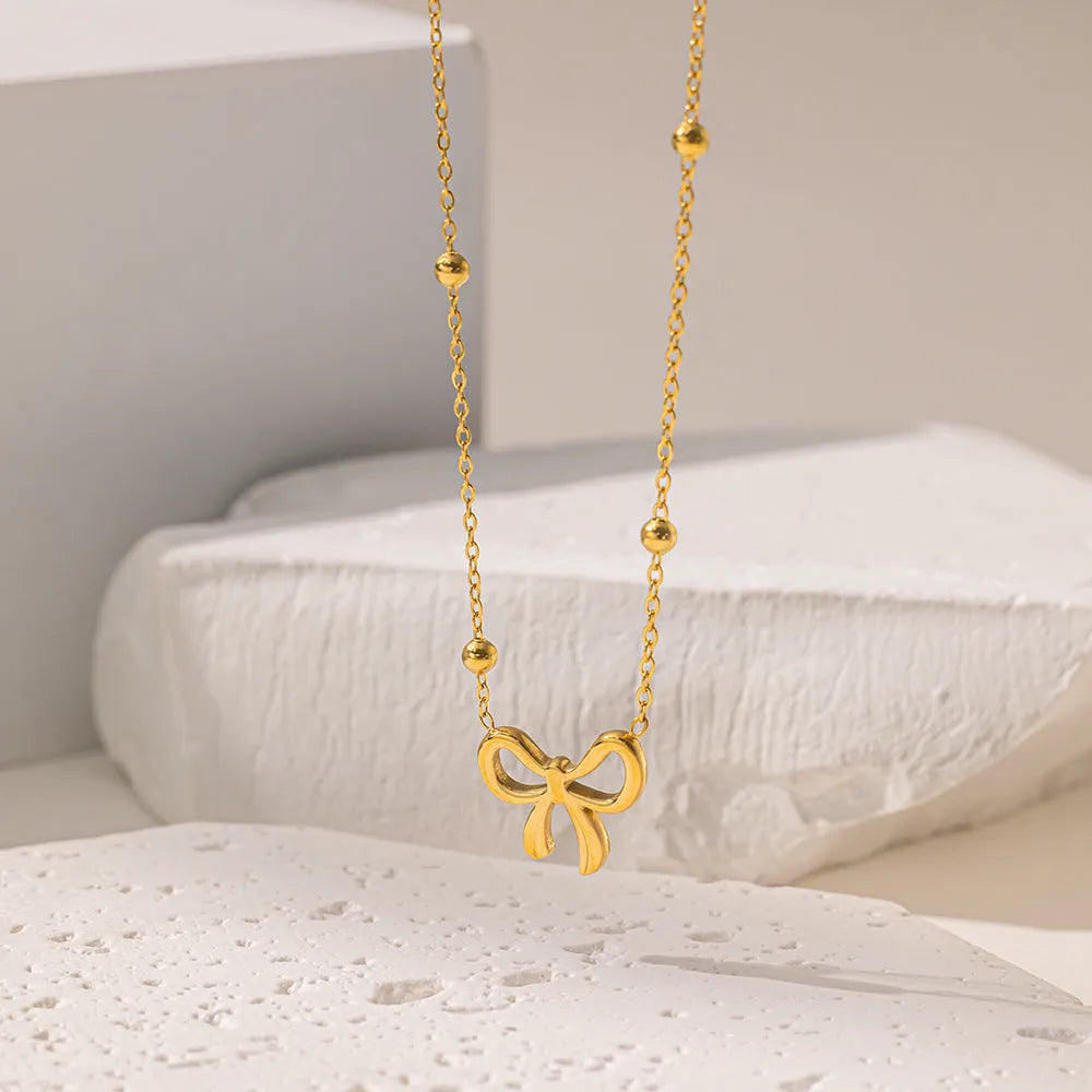 Gold bow necklace for women with cross chain design and adjustable length