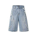 Straight cut denim shorts with raw edge distressing in black, shown on a model.
