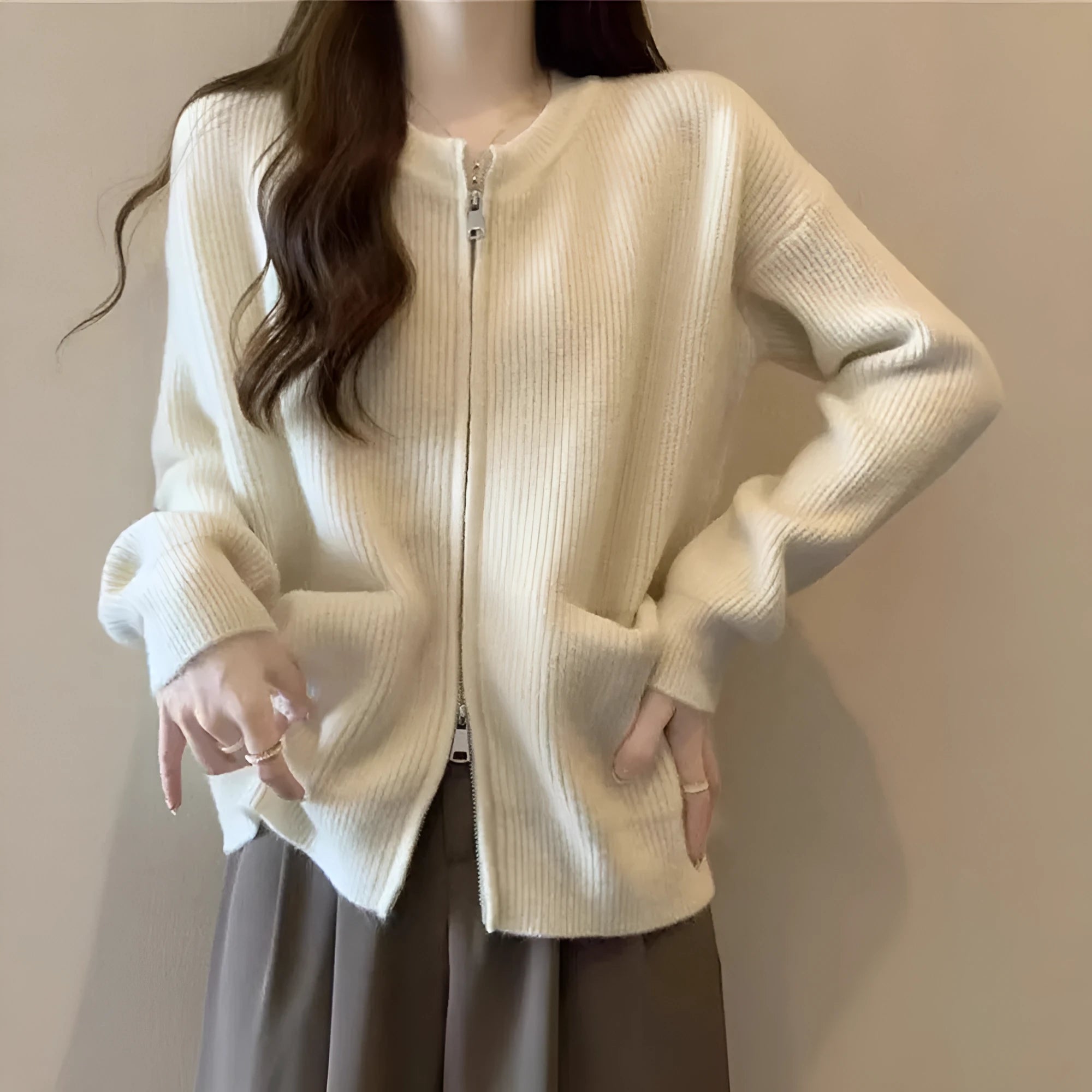 Beige viscose fibre sweater coat cardigan with long sleeves laid flat.