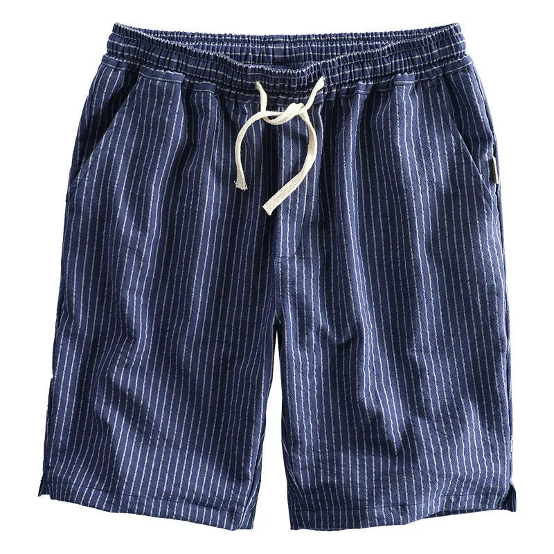 Man wearing black and white striped casual cotton shorts with a loose straight leg fit.