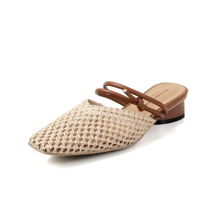 Women's black square toe slippers with chunky heel and breathable hollow-out design on a wooden floor