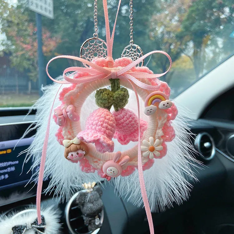 Handmade woven bell orchid car pendant in wool, shown in green, pink, purple, and yellow colour options.