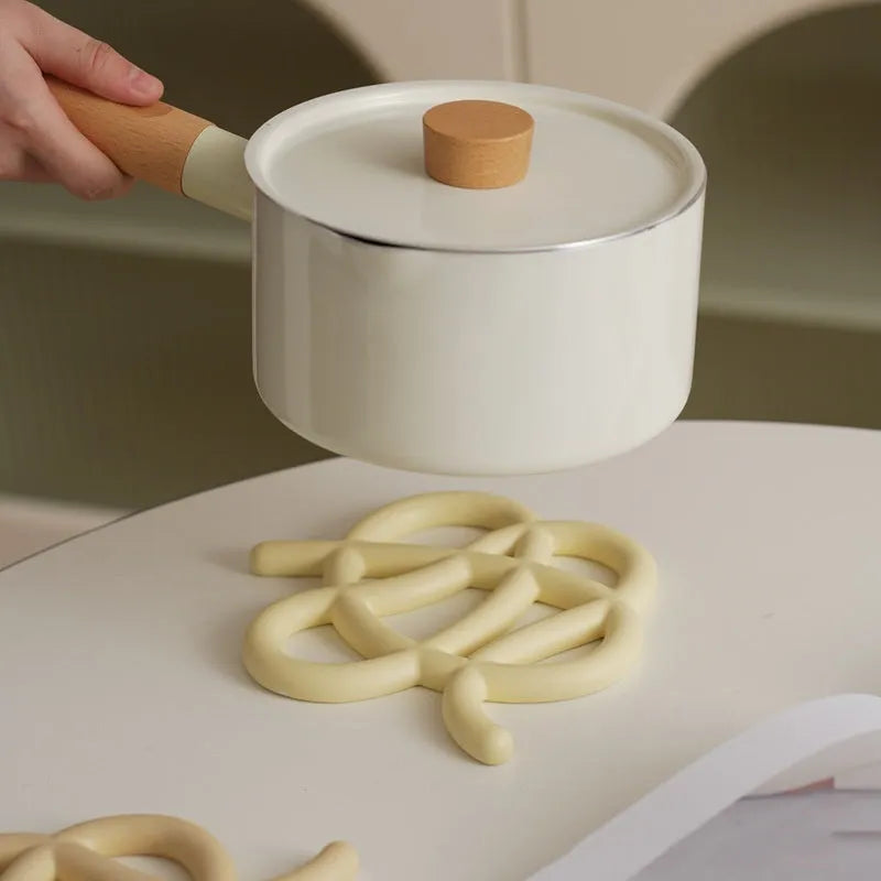 Ceramic heat proof mat in irregular shape on dining table