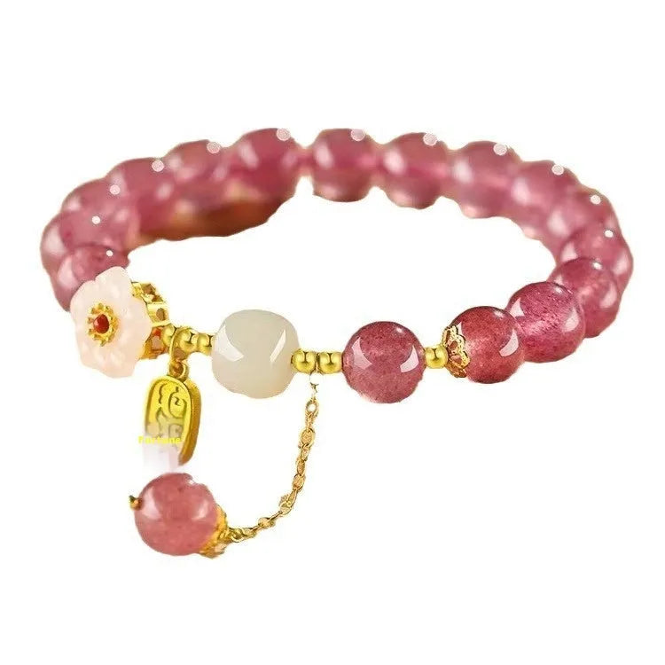 Handcrafted strawberry quartz and Hetian jade bracelet with peach blossom charm for girls.