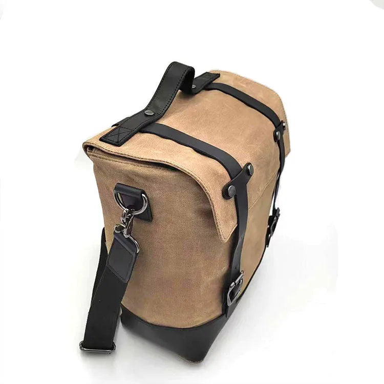 Waterproof canvas motorcycle side bag in black with cowhide accents and mounting straps