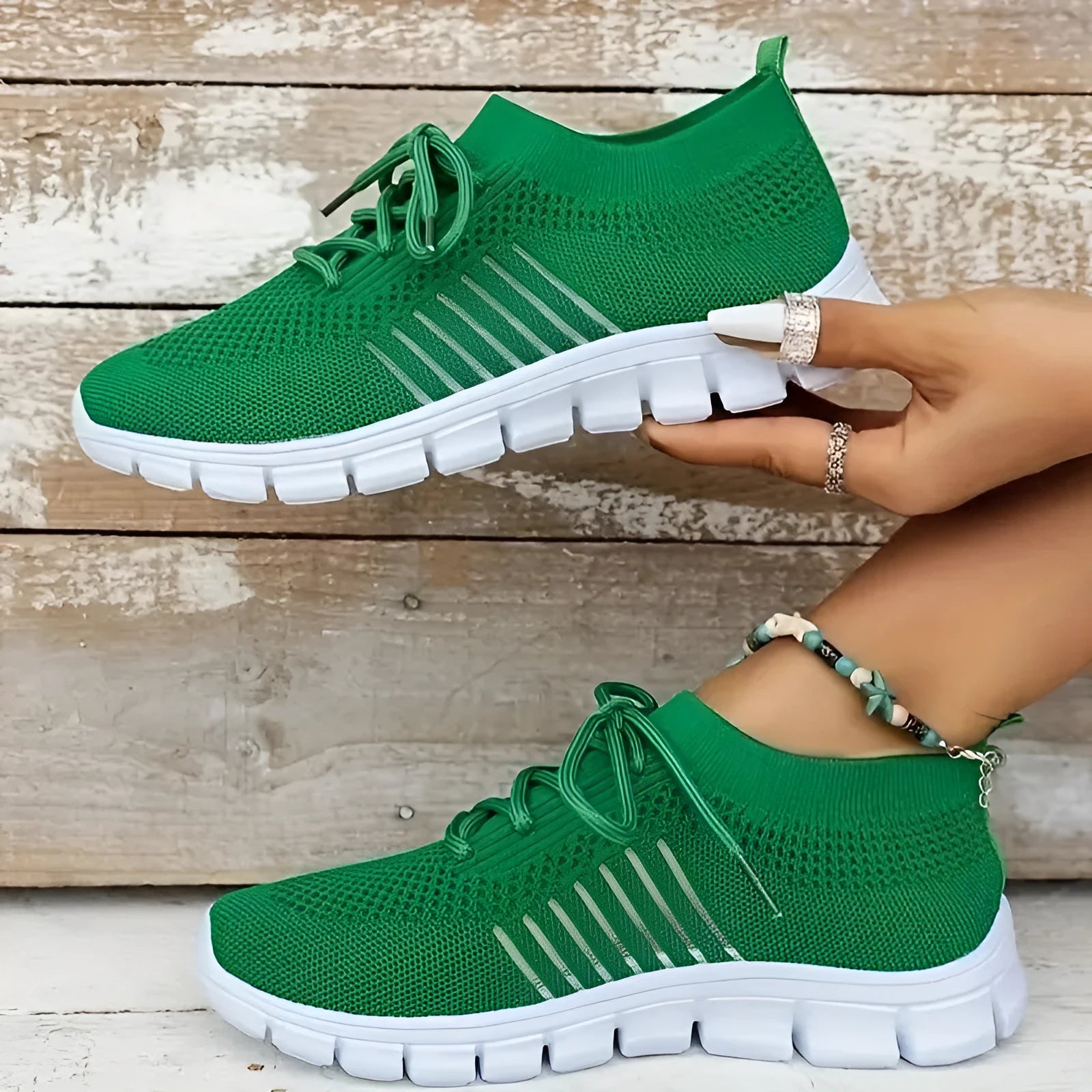 Women's breathable knit sports flat shoes in various colours on a light background.