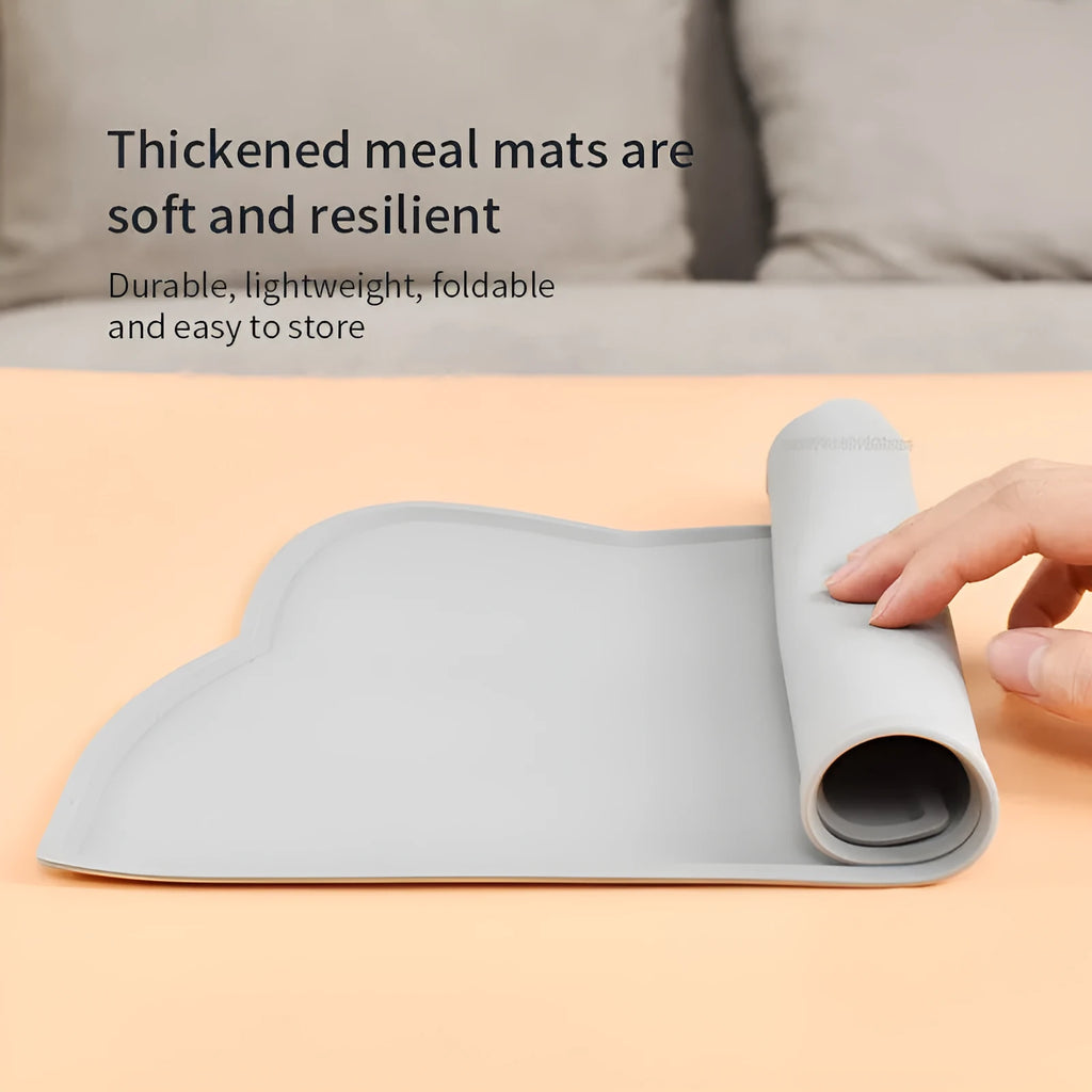 Blue silicone pet feeding mat with cat head design under food and water bowls