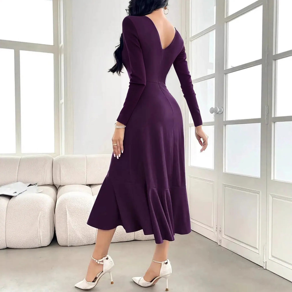 Purple women's long sleeve dress with round neck, mid waist, and ruffle detail on a hanger.