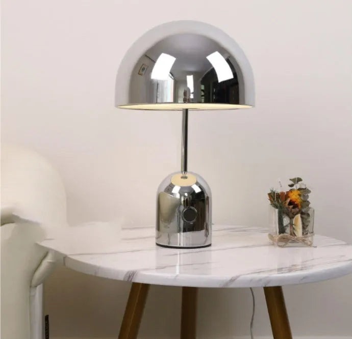 Mushroom table lamp with metal base in Rose Gold finish on wooden table
