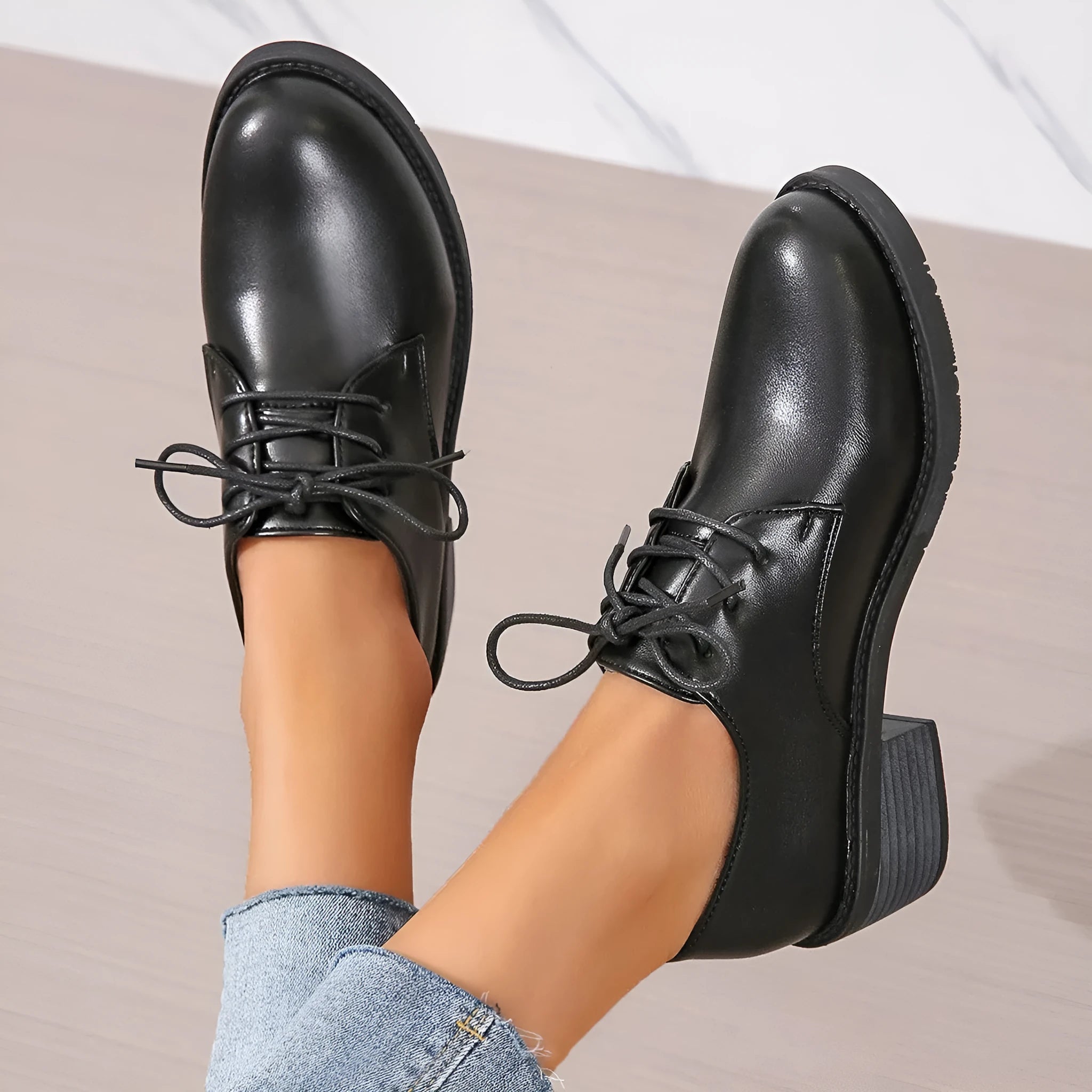 Black women's low-top work shoes with a thick chunky rubber heel and a PU leather upper