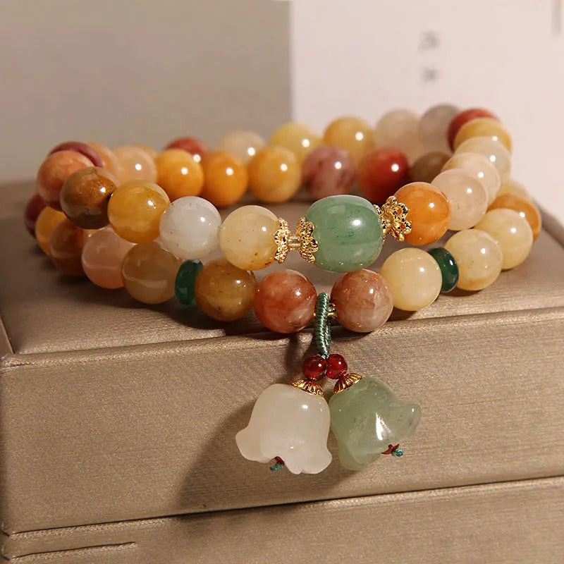 Natural green jade multi-layer wrap bracelet for women with a silver orchid pendant charm.