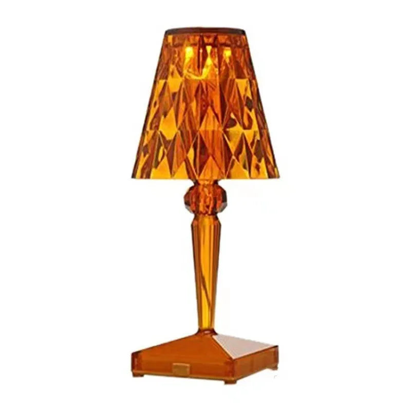 Rose gold portable touch control night light on a wooden surface.