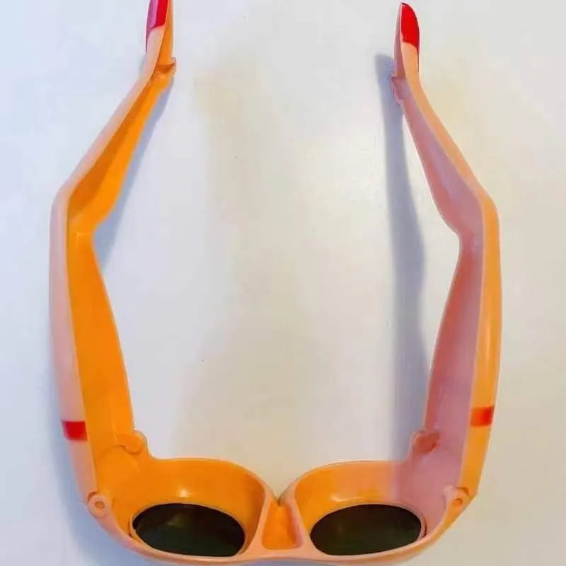 Orange plastic novelty sunglasses with oversized personality leg and hip design on the frame.