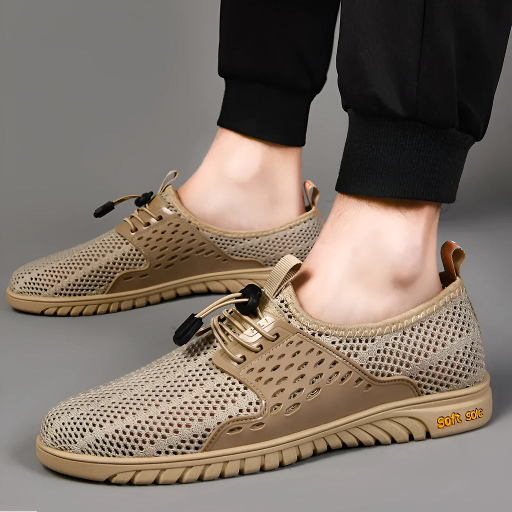 Men's black mesh casual sports shoe with elastic band fastening and rubber sole, shown on a white background.