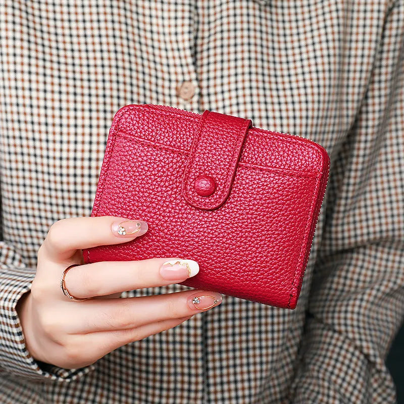 Women's Lychee pattern organ short wallet in breathable antibacterial PU, shown in beige, pink, black, and red colour options.