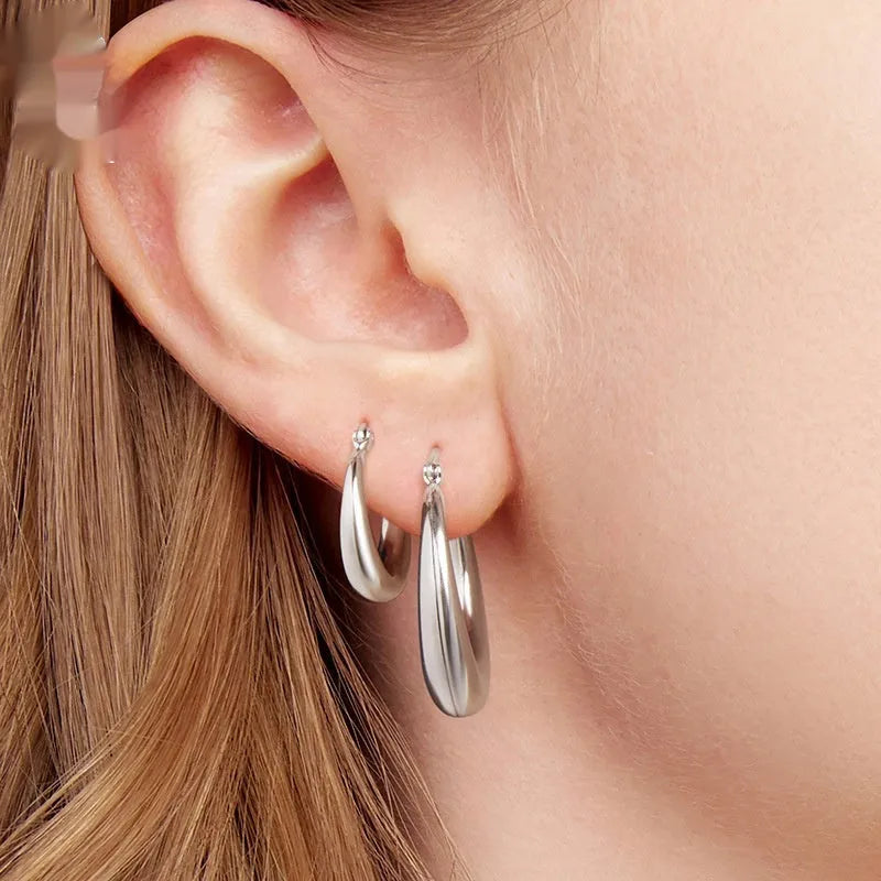 Copper geometric ring clip-on earrings with silver needle detail in three sizes.