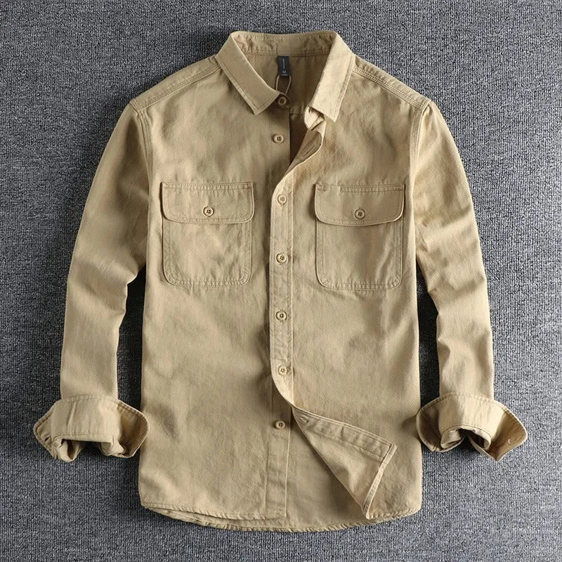 Man wearing a loose fit long sleeve overalls shirt in polyester, cardigan style.