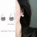 Golden beans drop-shaped earrings with full diamond embellishment and geometric design