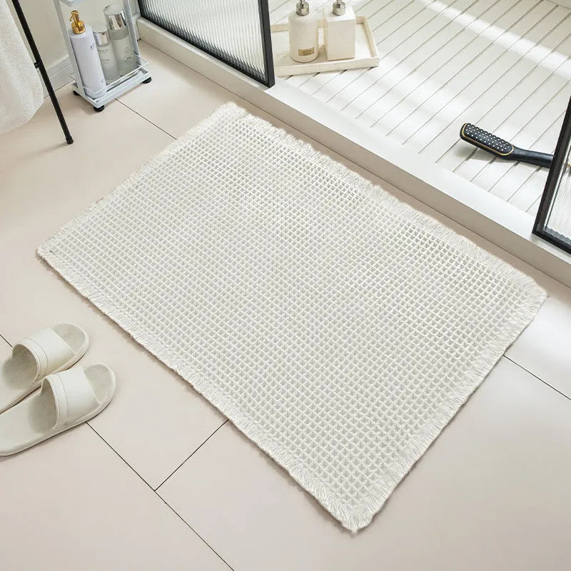 A checkered pattern polyester bathroom floor carpet showing non-slip backing.