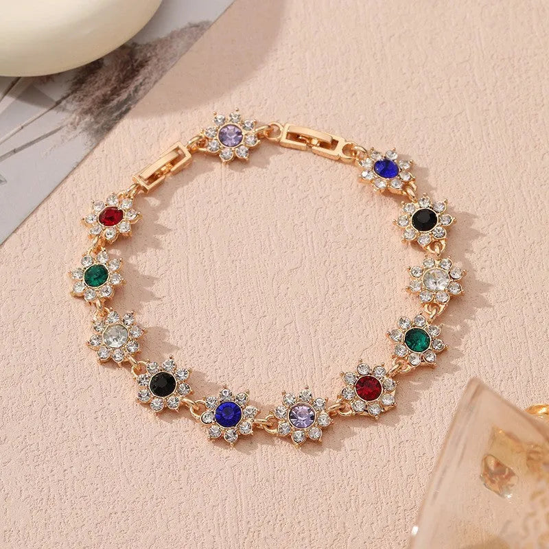 Gold and silver tone zinc alloy flower bracelet with electroplated coloured gemstones including crystal and diamond accents.