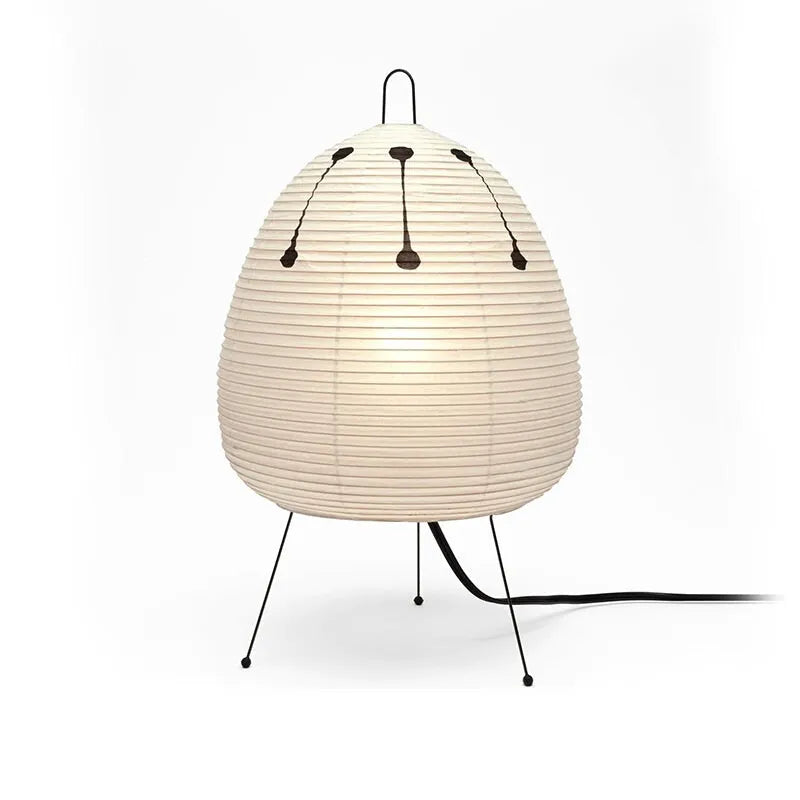 Japanese style table lamp with rice paper shade and aluminium base showing warm glow