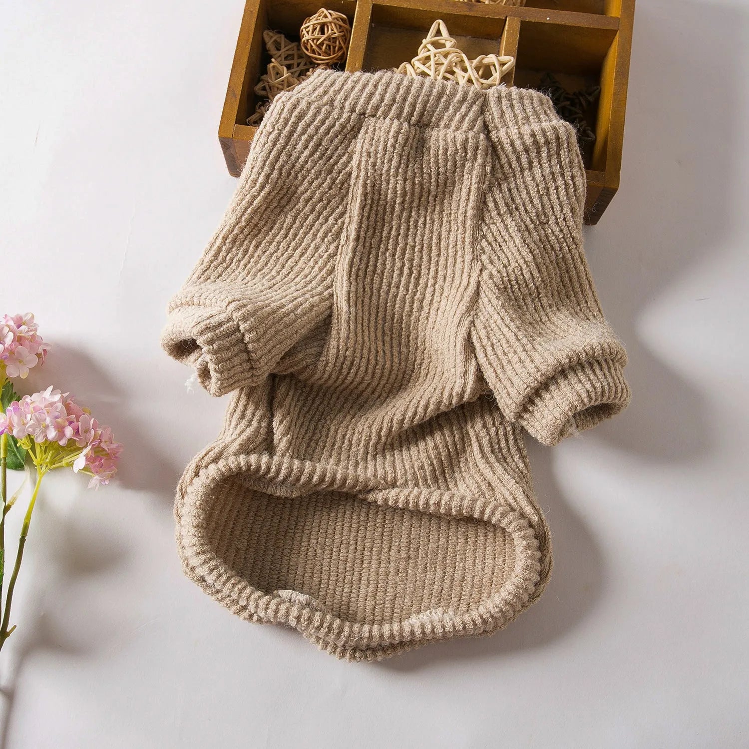 Brown knitted dog sweater pullover on small dog showing cloth construction and casual style