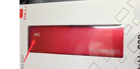 Ultra-thin metal portable external SSD drive in red, shown next to a laptop.