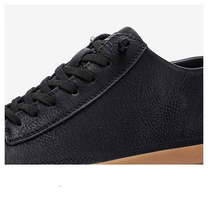 Men's black leather casual shoes with round toe, flat heel, and white laces on a rubber sole.