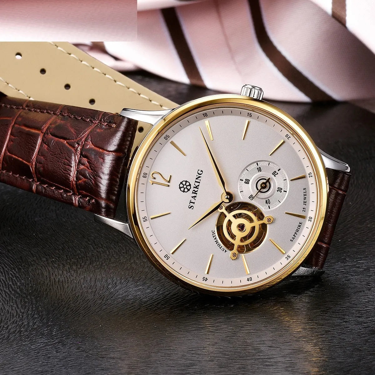 Men's steel and brown leather automatic business watch with hollow dial on white background