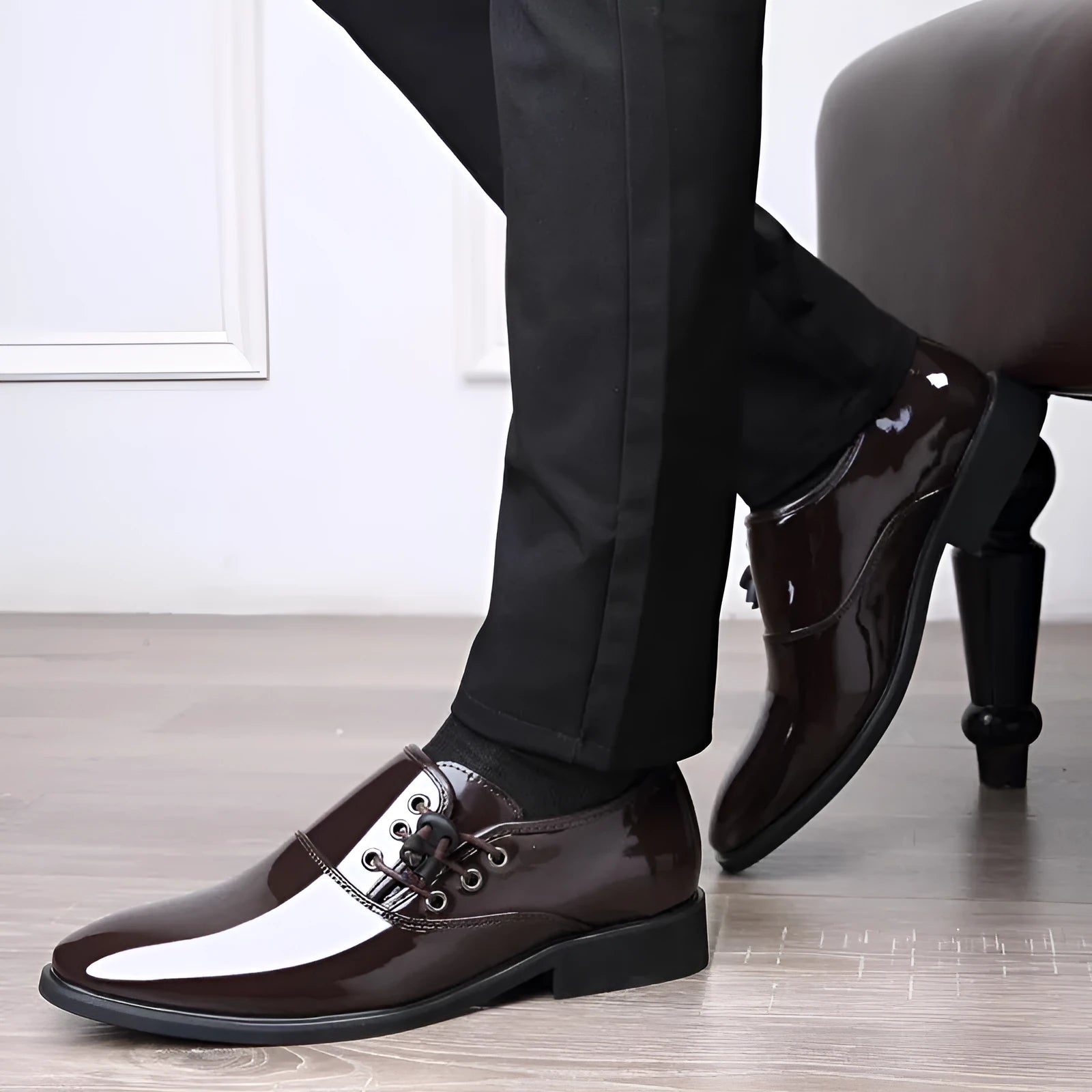 Men's black formal slip-on shoes with a round toe and square heel on a rubber sole.