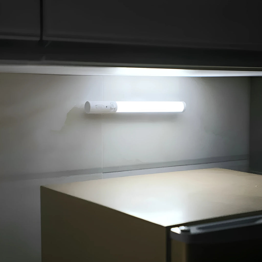 Slim white human induction cabinet wall light with magnetic back for installation on metal surfaces