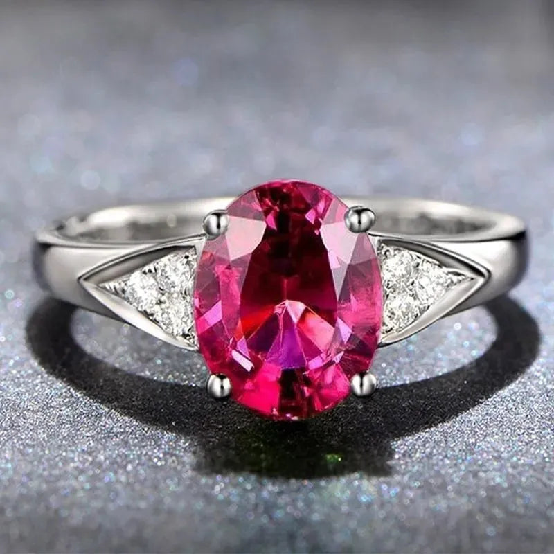 A women's court-style zircon ring showing an inlaid heart, water drop, or bell pattern in blue, green, light blue, or red.