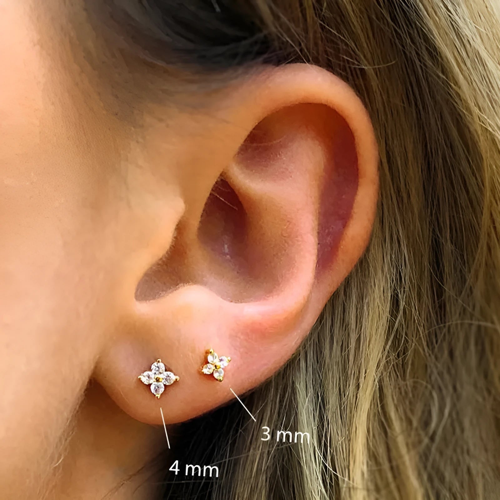 S925 sterling silver petal crystal flower stud earrings in gold finish on a white background.