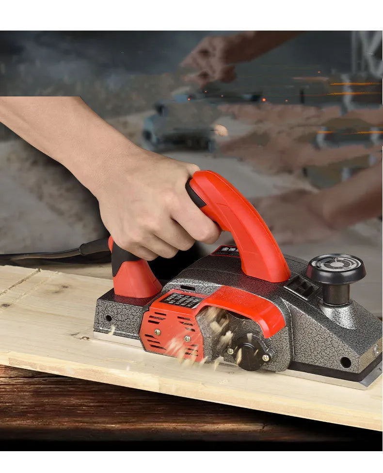 Red desktop electric wood planer with aluminium housing and 82mm planing width