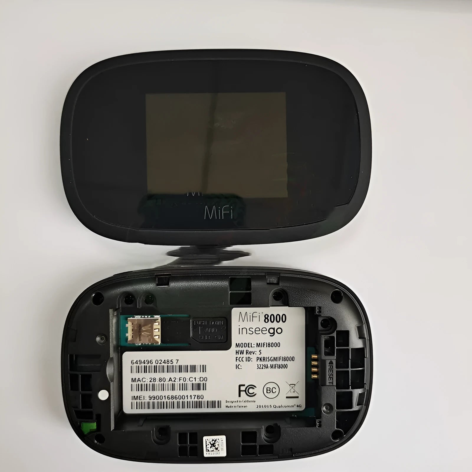 Black mifi8000 4G portable wireless router with battery and cable on a white background.