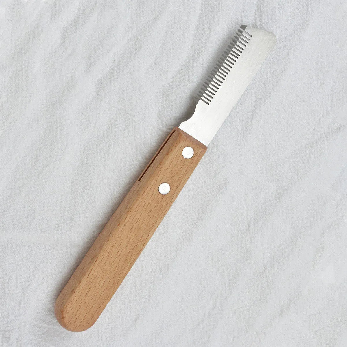 Pet stripping comb with wood handle for removing floating hair and mats from dogs and cats.