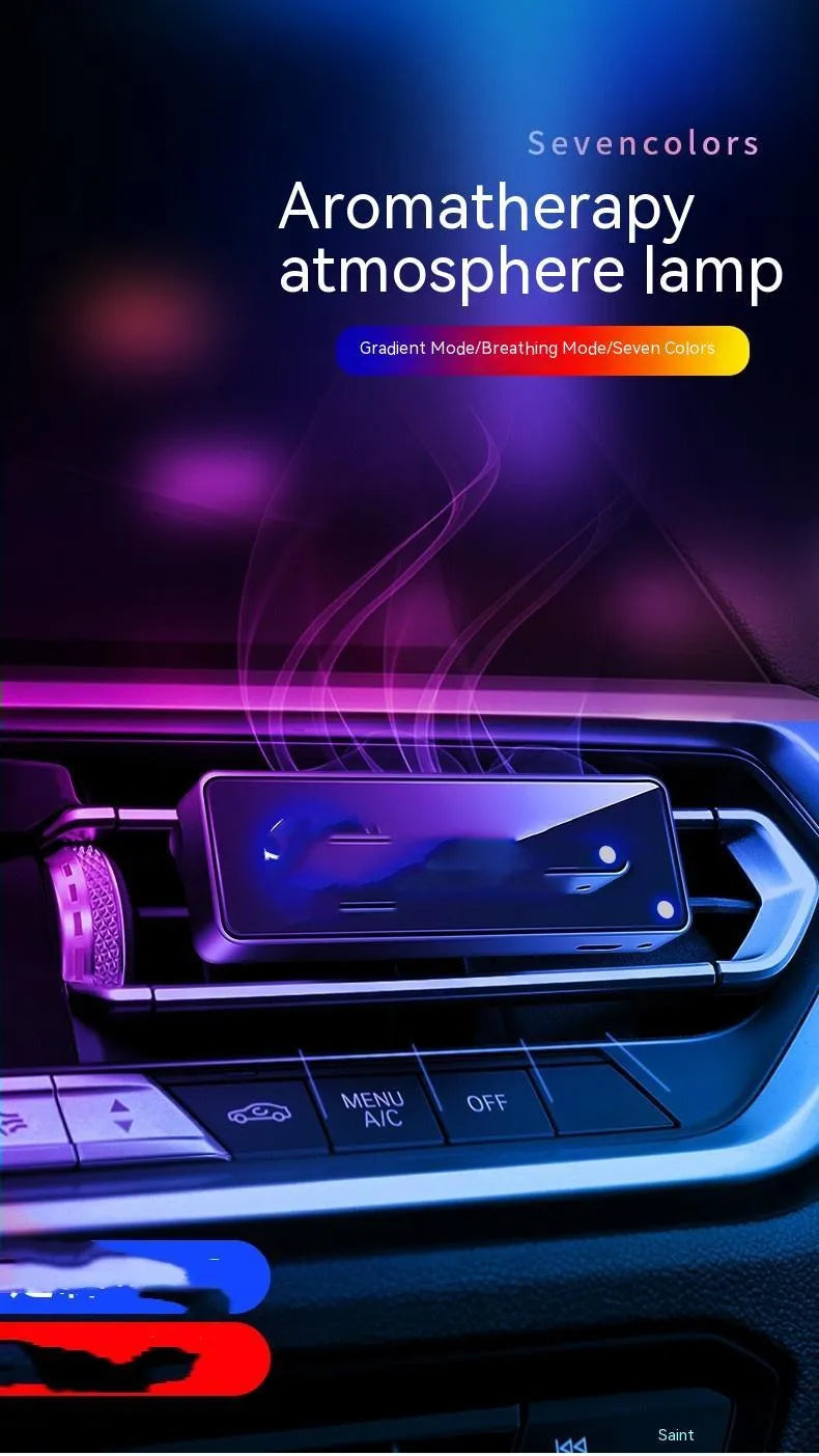 Black automobile aromatherapy LED light attached to a car air vent with a fragrance stick.