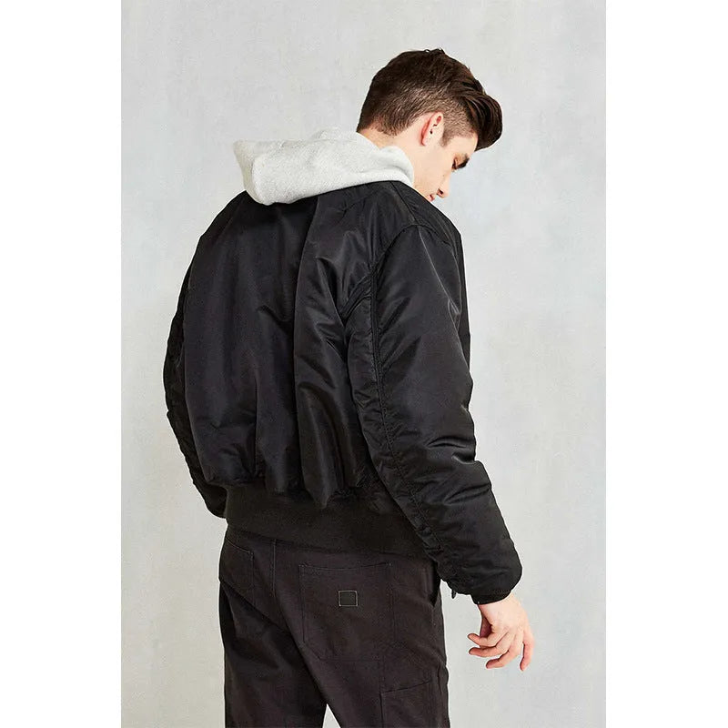 Men's loose-fit army green nylon pilot jacket on a hanger