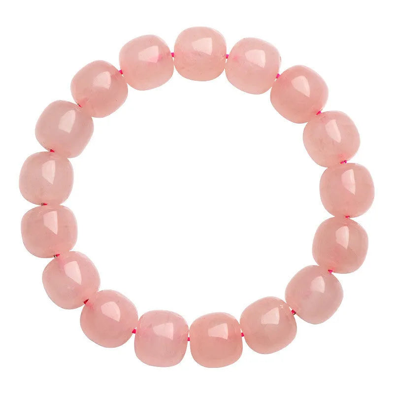 Pink natural crystal bracelet with barrel-shaped beads measuring 8 to 10 mm.