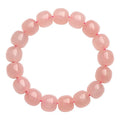 Pink natural crystal bracelet with barrel-shaped beads measuring 8 to 10 mm.