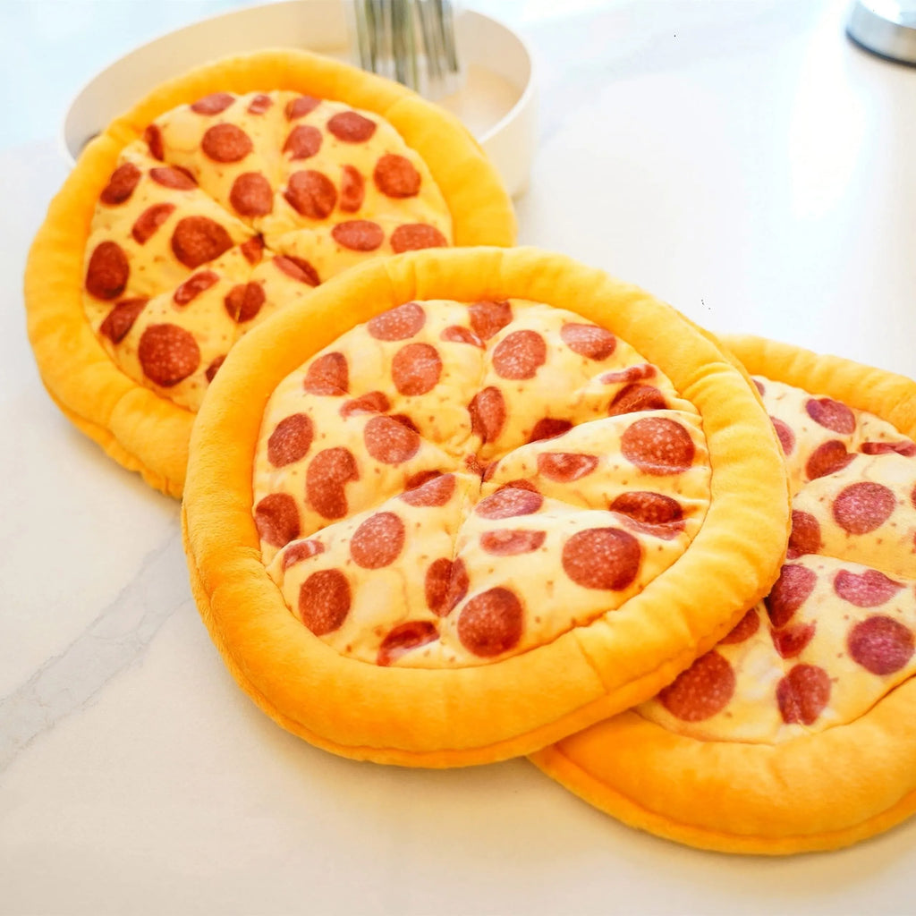 Yellow pizza slice squeaky plush dog chewing toy on white background