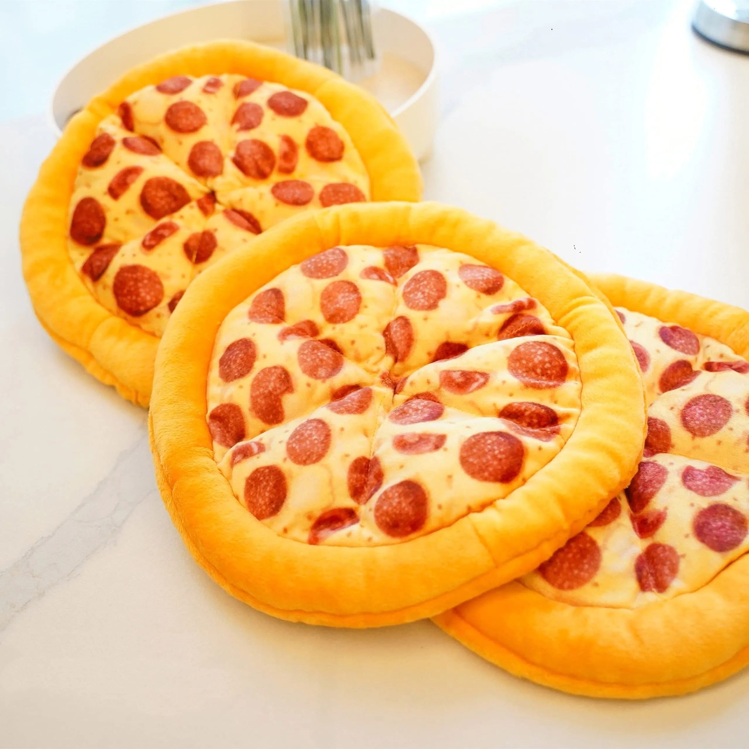 Yellow pizza slice squeaky plush dog chewing toy on white background