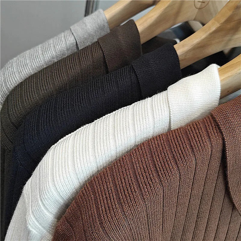 Men's loose grey knitted sweater with a textured striped lapel, shown on a model.