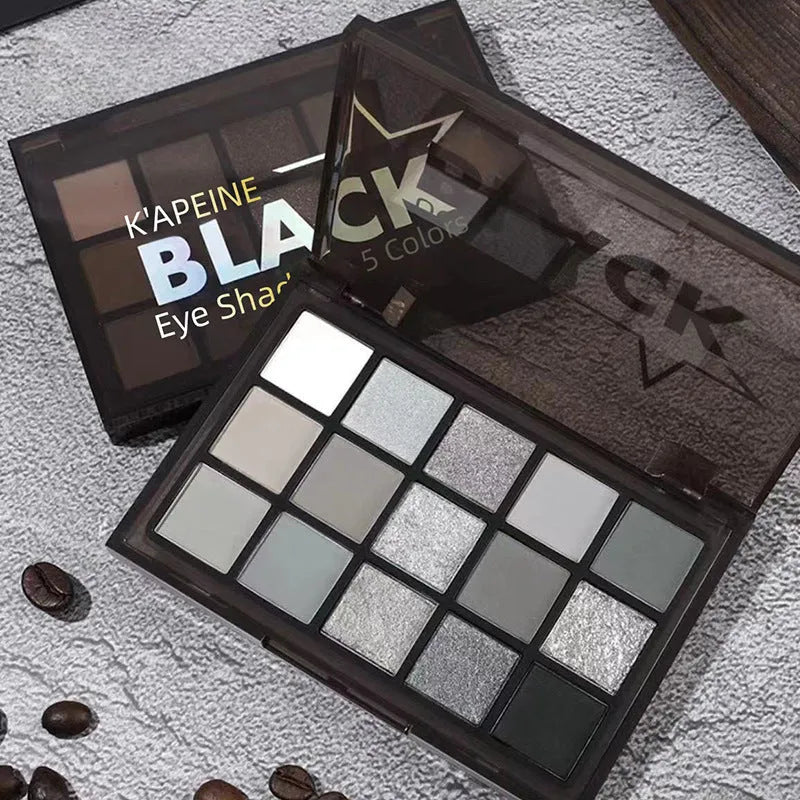 15-colour eyeshadow palette showing matte and shimmer shades including grey, black, brown, blue and earth tones