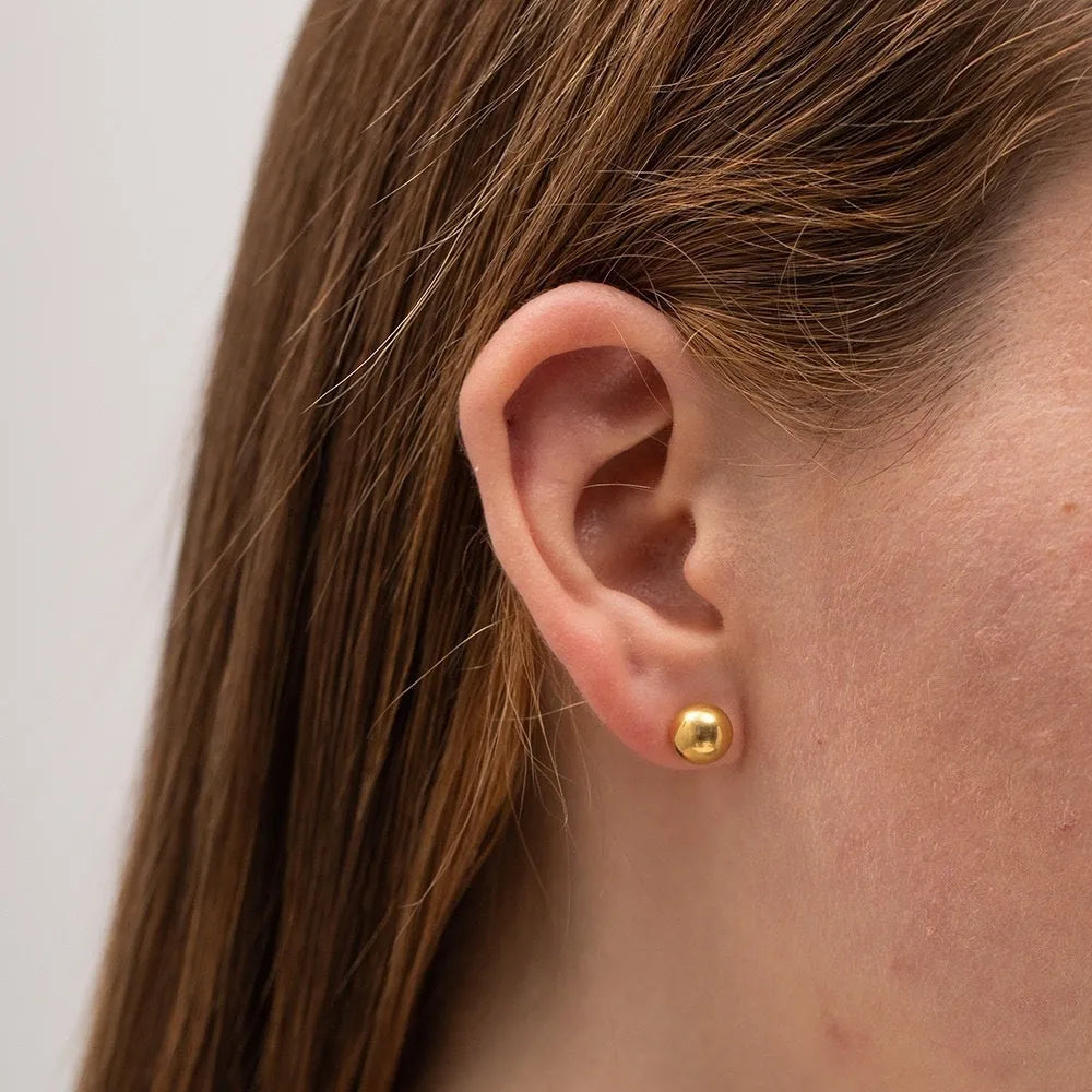 Stainless steel ball stud earrings in gold and silver tones, showing different sizes from 3mm to 6mm.
