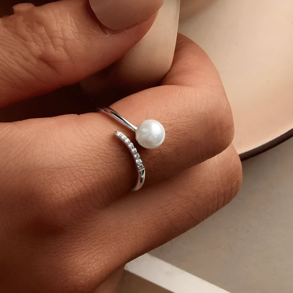 Shell pearls ring with S925 sterling silver construction and adjustable open loop design featuring natural pearl accent