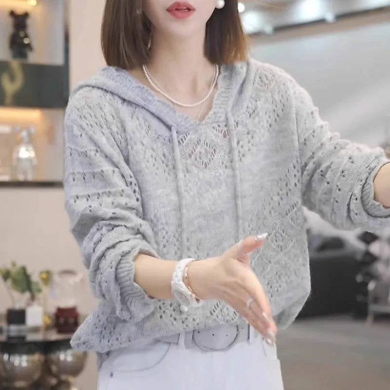 Women's loose blue crochet knit hooded longsuit undershirt with long sleeves.