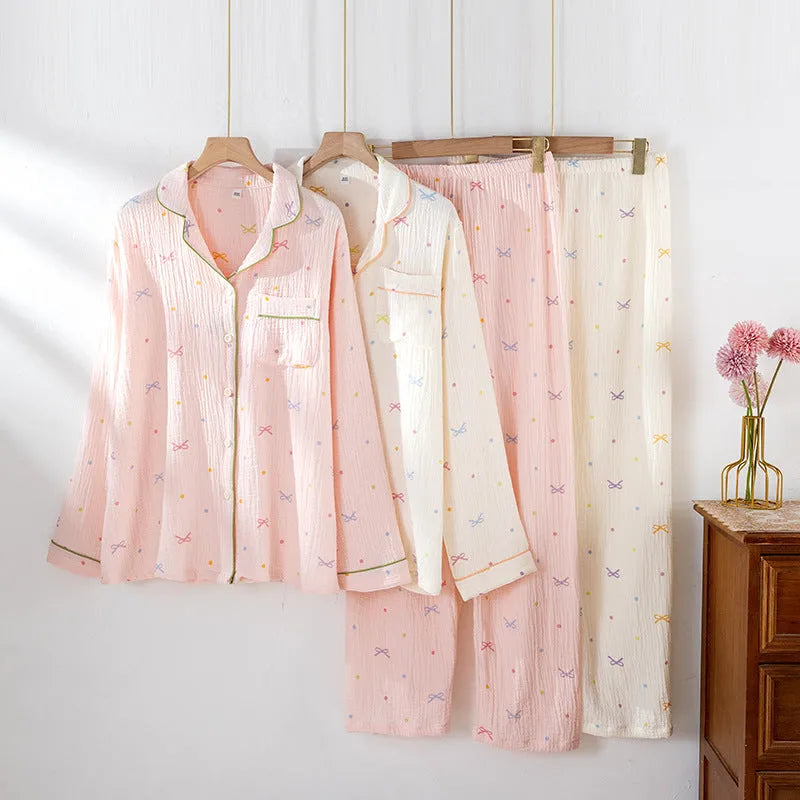 Women's beige cotton crepe pajama set with long sleeves and trousers on a hanger.